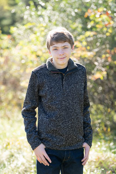 Ryan sitting on a tree stump